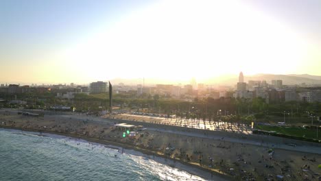 experience the vibrant charm of barcelona at sunset with its iconic beach, lively promenade, and stunning city skyline against a golden mediterranean backdrop.