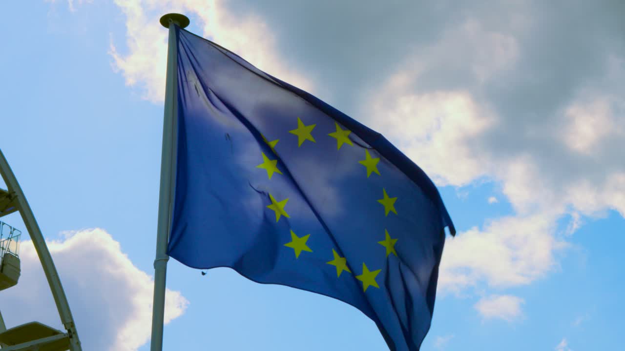 EU European Union Flag Waving in Wind in Slow Motion with Bright Sunny Blue Sky Clouds Background. Patriotic, Nationalistic Concept Footage 4K