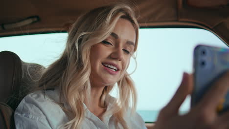 woman smiling video meeting smartphone in car close up. happy girl streaming.