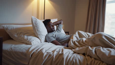 man relaxing in bed