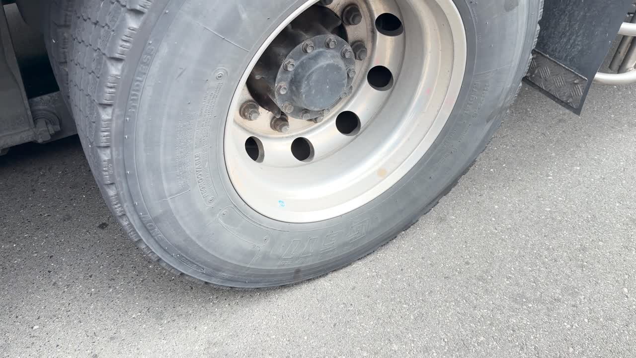 High angle close up shot of heavy duty truck tires parked on asphalt in Japan
