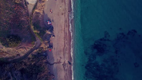 drone flying down at playa de maro, andalusia, south of spain