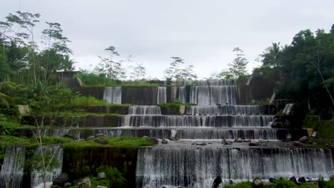 Aerial-view-on-Grojogan-Watu-Purbo-waterfall-and-Mount-Merapi-on-Java,-Indonesia