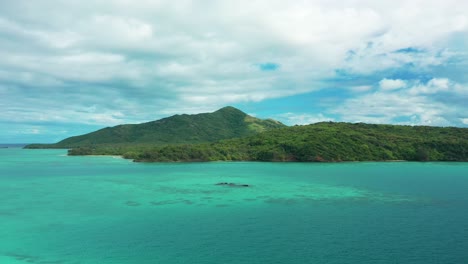 the beautiful, pristine turquoise waves of the fiji mountain islands - aerial