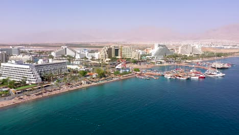 aerial footage of hotels and resorts eilat's coastline, a beautiful city at south israel on the red sea shore