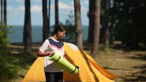 girl camping with yoga mat