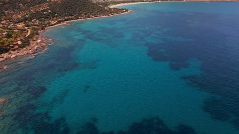 aerial view of sardinia island, italy, picturesque coastline and blue waters of mediterranean sea, tilt up drone shot