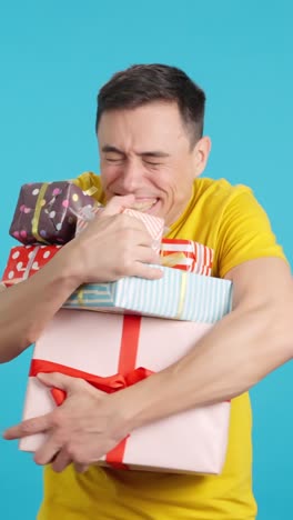 man holding a stack of gifts