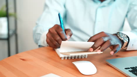 person taking notes at desk