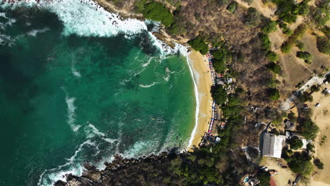 aerial view above the playa carrizalillo beach in sunny puerto escondido, mexico - top down, drone shot