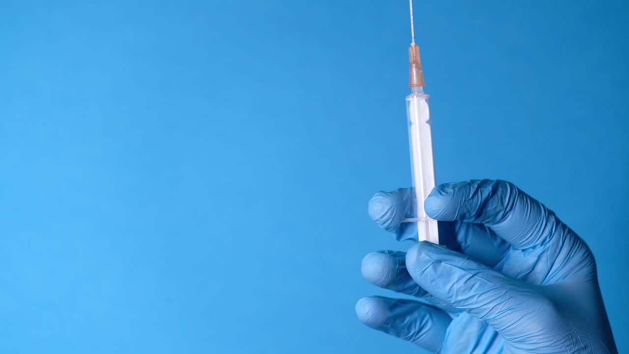 Syringe in a gloved hand