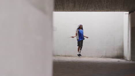 side view man with prosthetic leg doing skipping rope