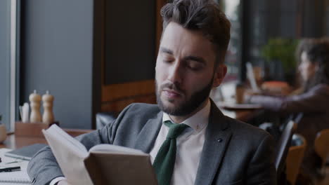 businessman reading in a cafe