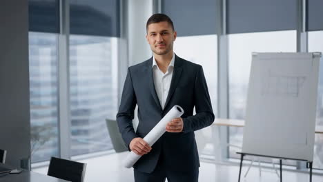 professional businessman in office with blueprint