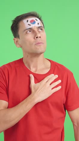 Man listening to the South Korea national anthem with solemnity