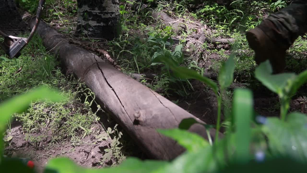 산에서 통나무를 걷고 넘어지는 사냥꾼