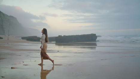 positive girl laughing beach wide shot. carefree woman having fun at evening