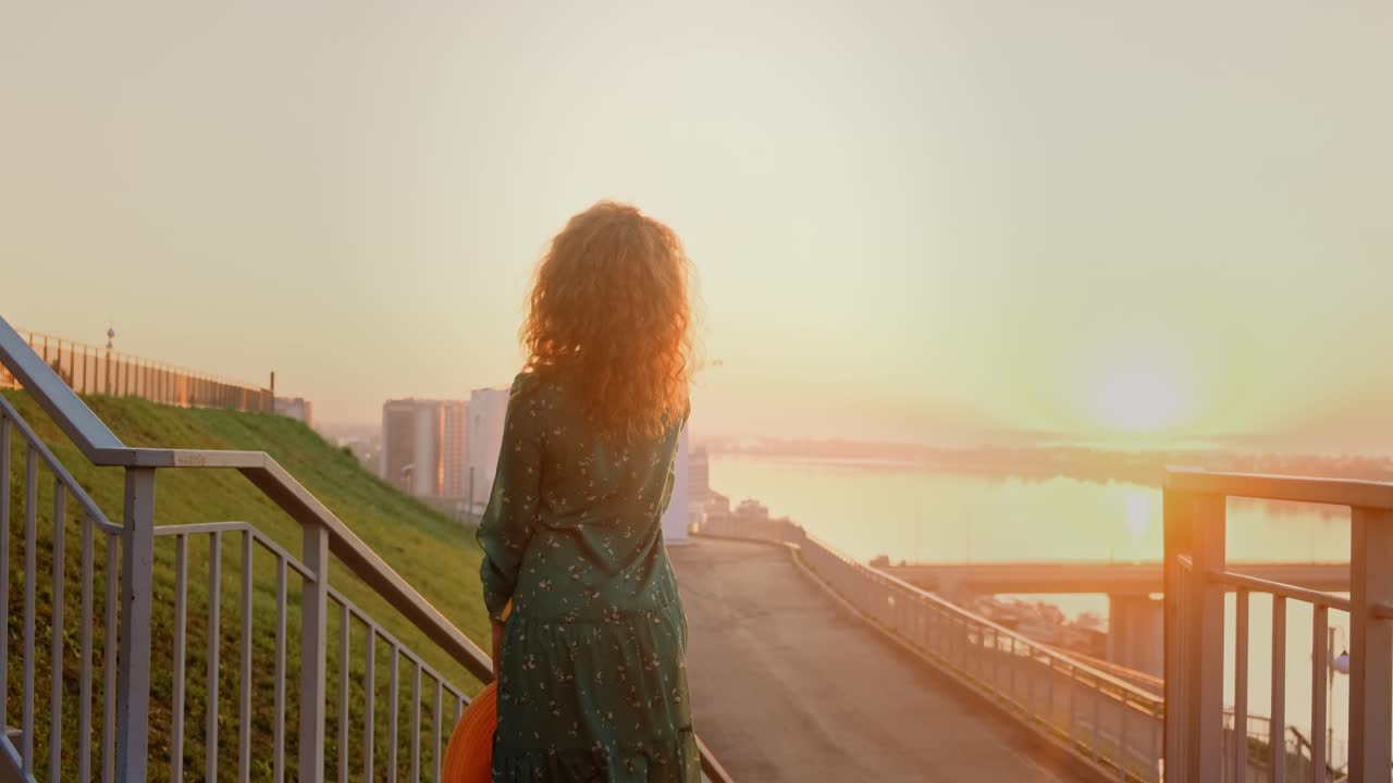 Woman enjoying a sunrise view from the city stairs