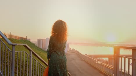 woman enjoying a sunrise view from the city stairs