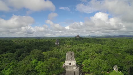 aerial shot over the tikal pyramids in guatemala