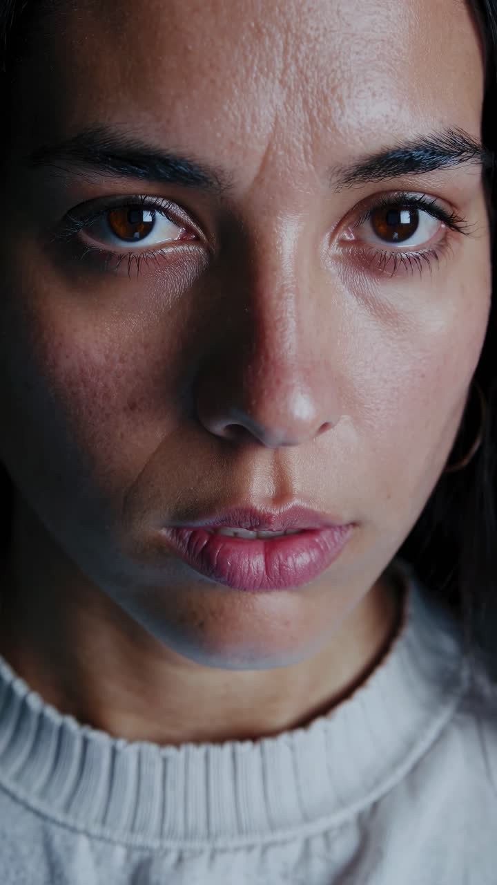 Close-up portrait of a young woman showing concern and worry with a ...
