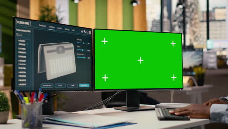 engineer using green screen mockup pc to create advanced solar cell technology