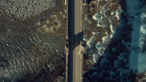 symmetric zenithal aerial drone view of historical old stone bridge