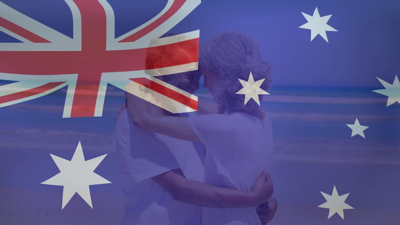 Senior couple starting embracing and swaying at beach, flag overlaying showing romance for tourism