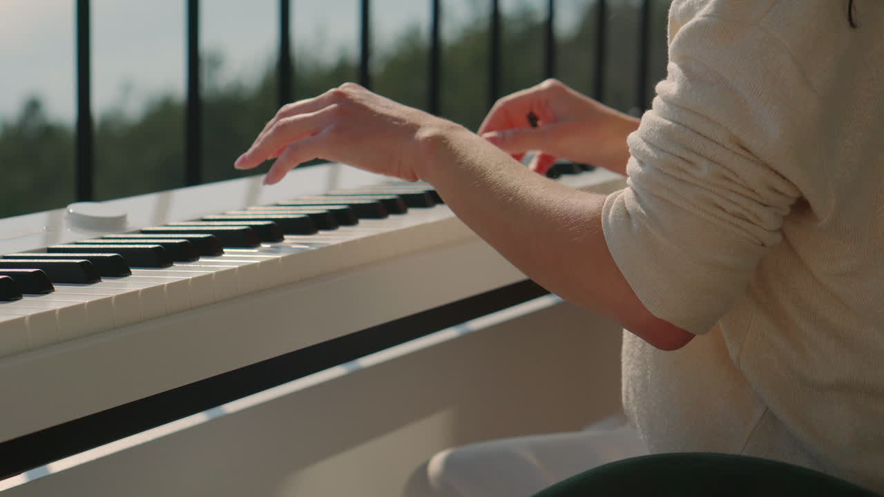 Woman playing piano on a balcony
