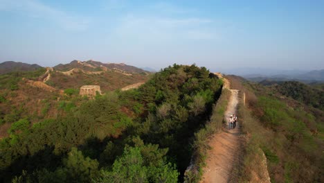 two people hiking along the great wall of china