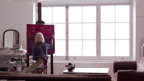 artist works on painting in daylight studio shot on r3d