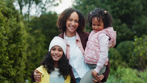 a mother and her two daughters posing outdoors