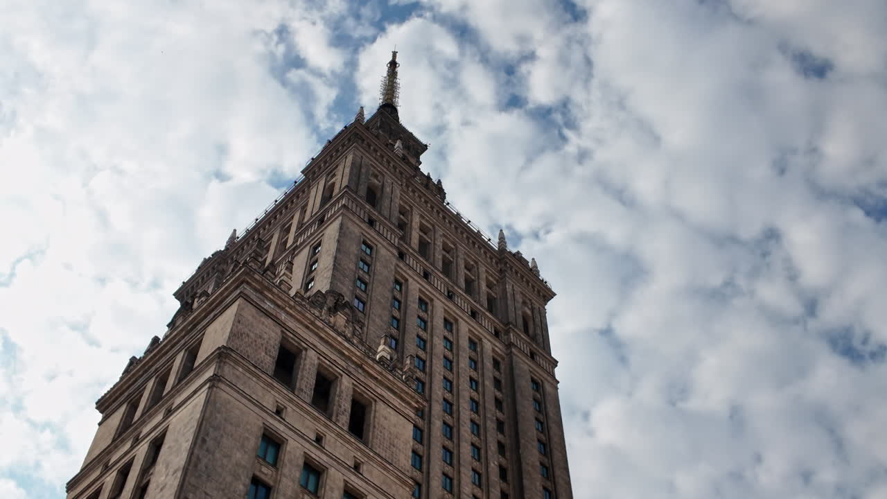 Palace of Culture and Science in Warsaw, Poland, towering over the skyline under a cloudy sky