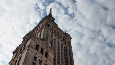 palace of culture and science in warsaw, poland, towering over the skyline under a cloudy sky