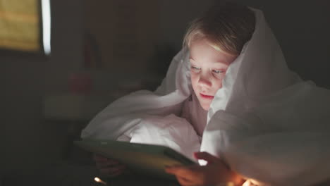 blanket, girl and tablet in bedroom at night