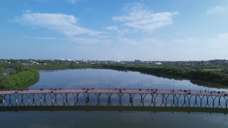 People-crossing-a-bridge-and-cycling