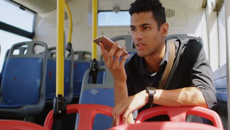 Male-commuter-talking-on-mobile-phone-while-travelling-in-bus-4k