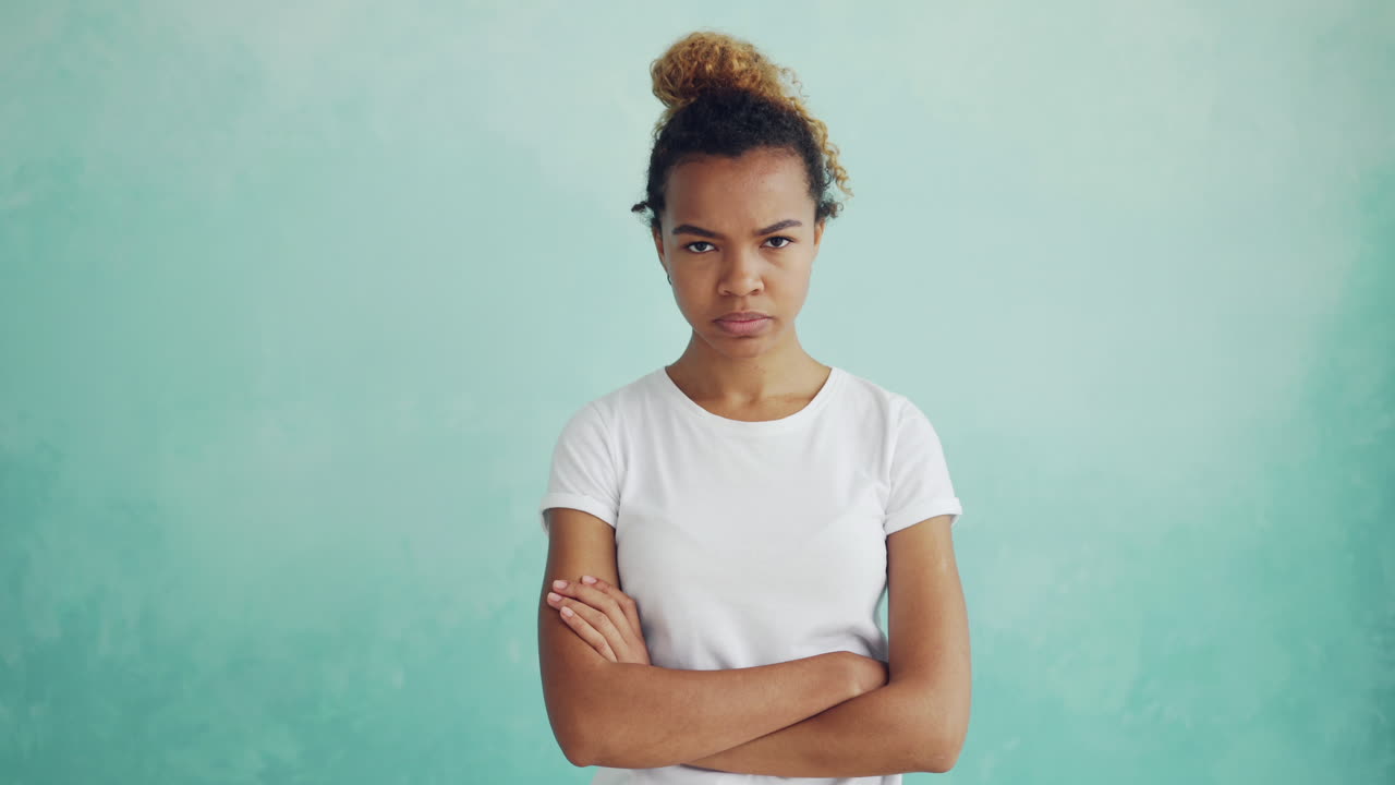 Woman with arms crossed, looking displeased