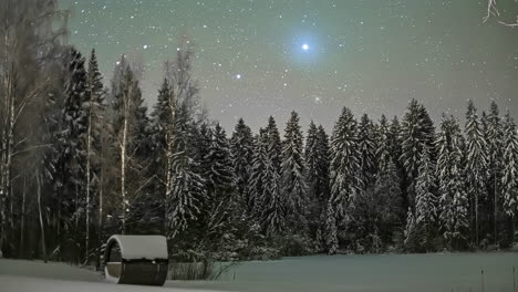 wooden cabin covered with snow under the starry night sky