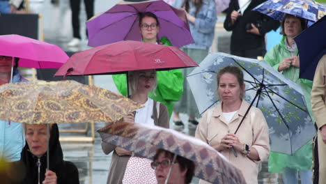 people with umbrellas in the rain