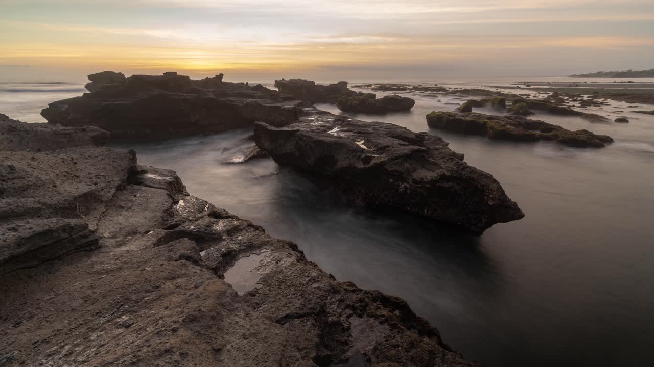 Sunset over Volcanic Rocks at a Bali Beach