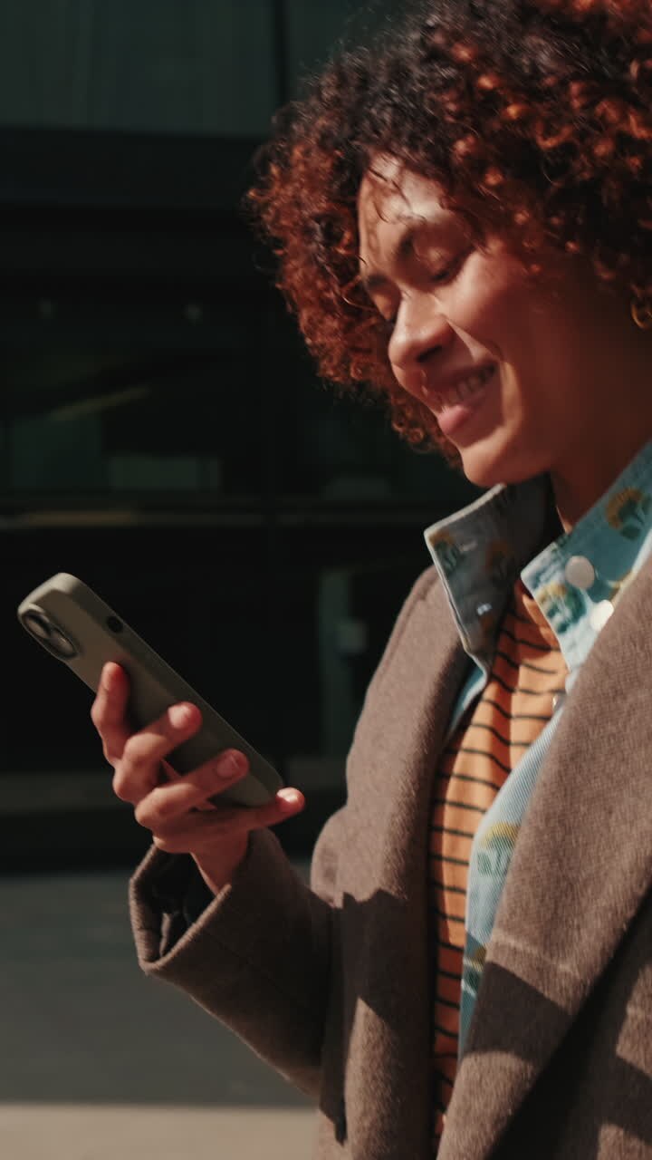 Happy Woman Walking and Using Her Phone
