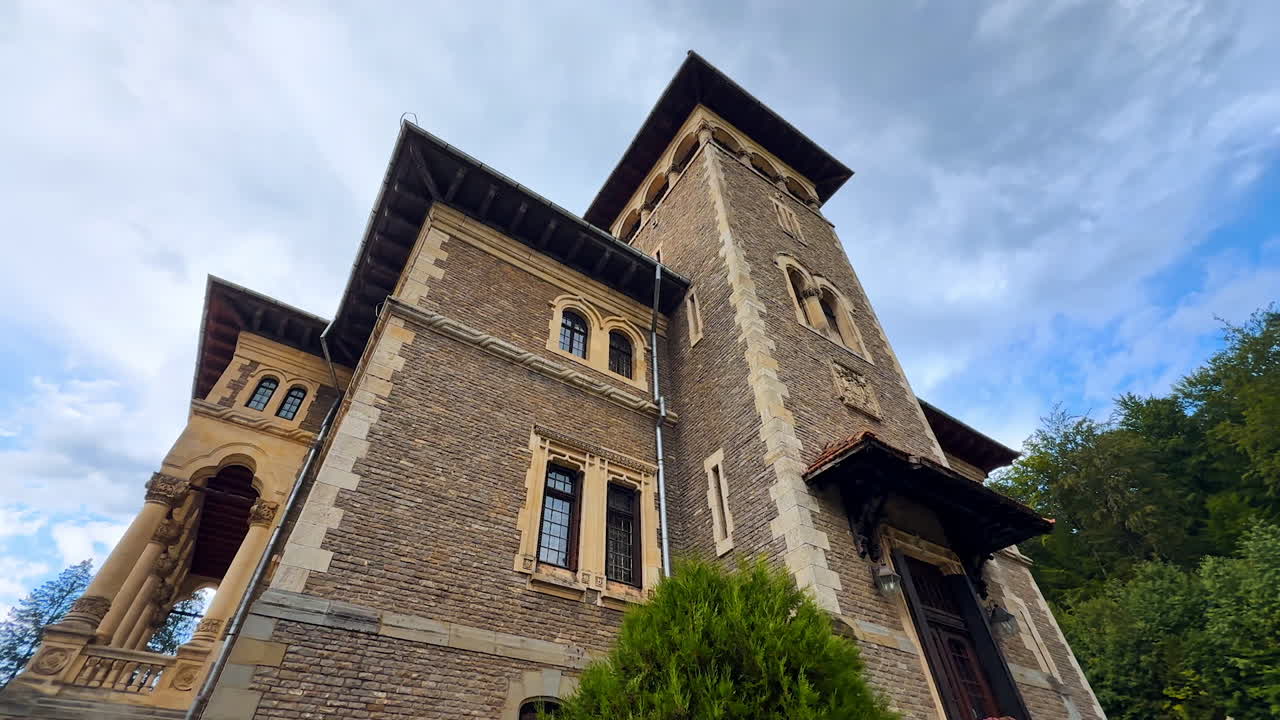 Beautiful brick wall building with arched windows. Low angle view on the famous Cantacuzino Castle, Bu?teni, Romania