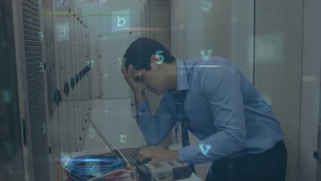 hombre preocupado en una sala de servidores de computadora usando una computadora portátil