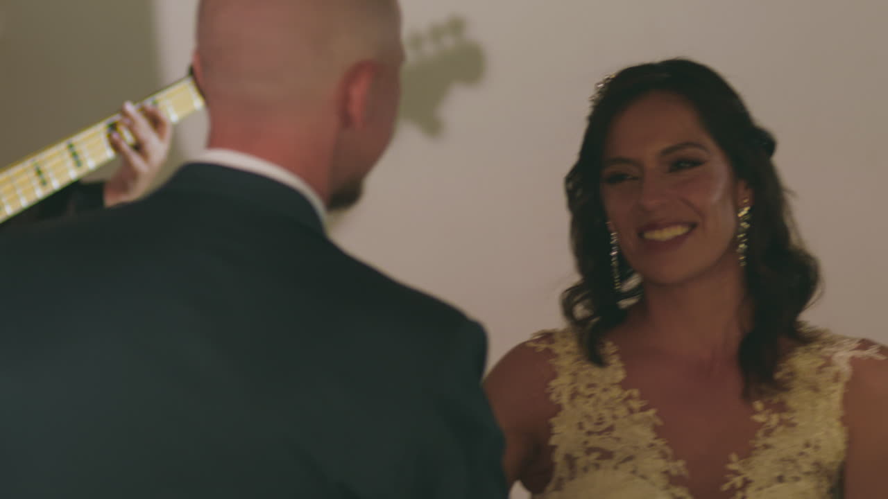 Emotional clip of a newlywed couple dancing joyfully during their wedding party.