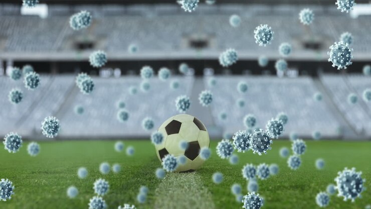 Cellule di Covid-19 su un pallone da calcio in uno stadio sportivo