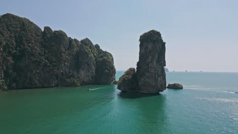 Moving-drone-shot-of-Pai-Plong-Beach-with-speedboats-on-sea-in-Krabi,-Thailand