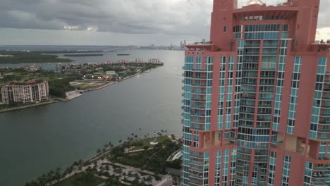 Panoramic-aerial-view-revealing-South-Beach-Miami-cityscape,-Downtown-Miami-oceanside-skyline-buildings-under-stormy-sky,-Florida,-USA