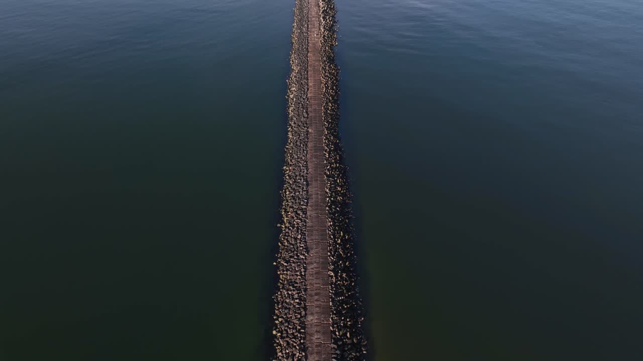 Aerial footage of a unique walkable mound built with reinforced concrete blocks near the North Sea. Filmed by drone.