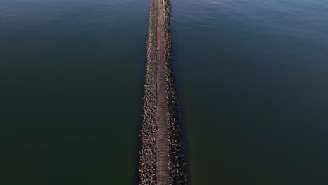 aerial footage of a unique walkable mound built with reinforced concrete blocks near the north sea. filmed by drone.